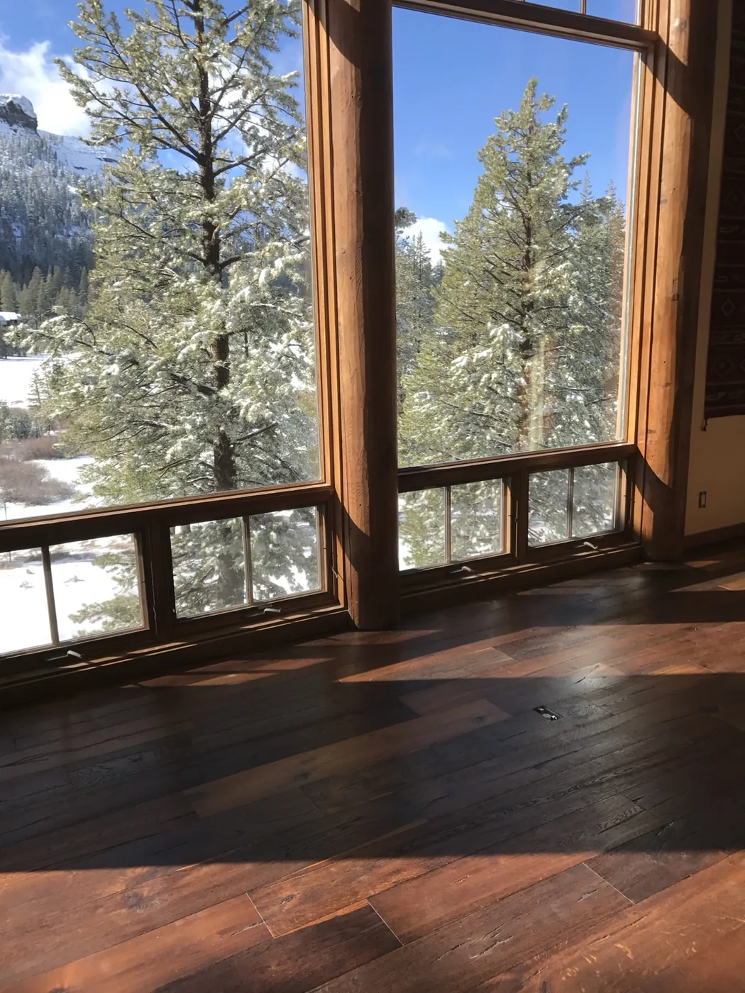 Engineered hardwood flooring inside a Kirkwood mountain cabin with snowy views