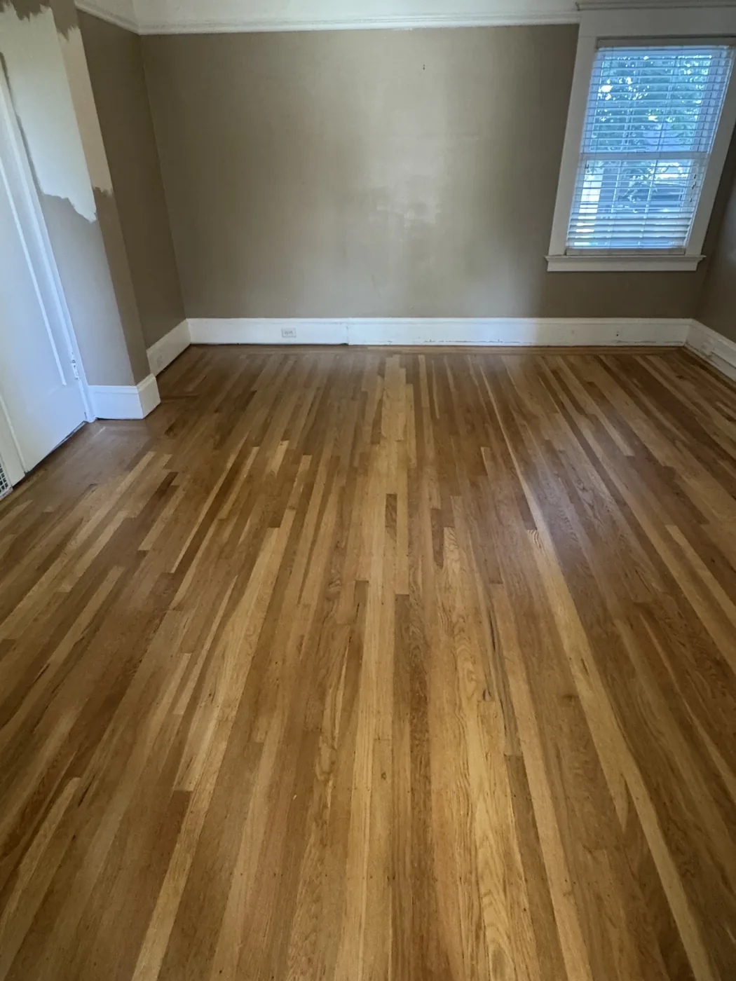 Restored 100-year-old white oak floor with lace-in repair